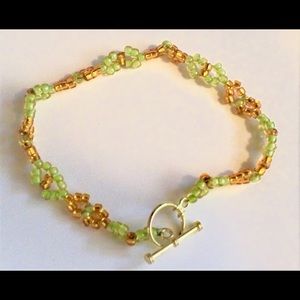 Green and gold glass beaded bracelet